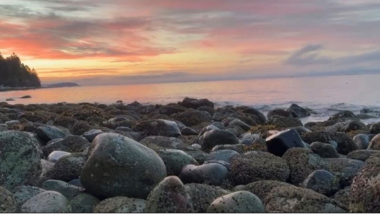 Sunset at the beach with lots of rocks
